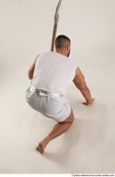 Man Adult Muscular Fighting with spear Kneeling poses Coat Latino
